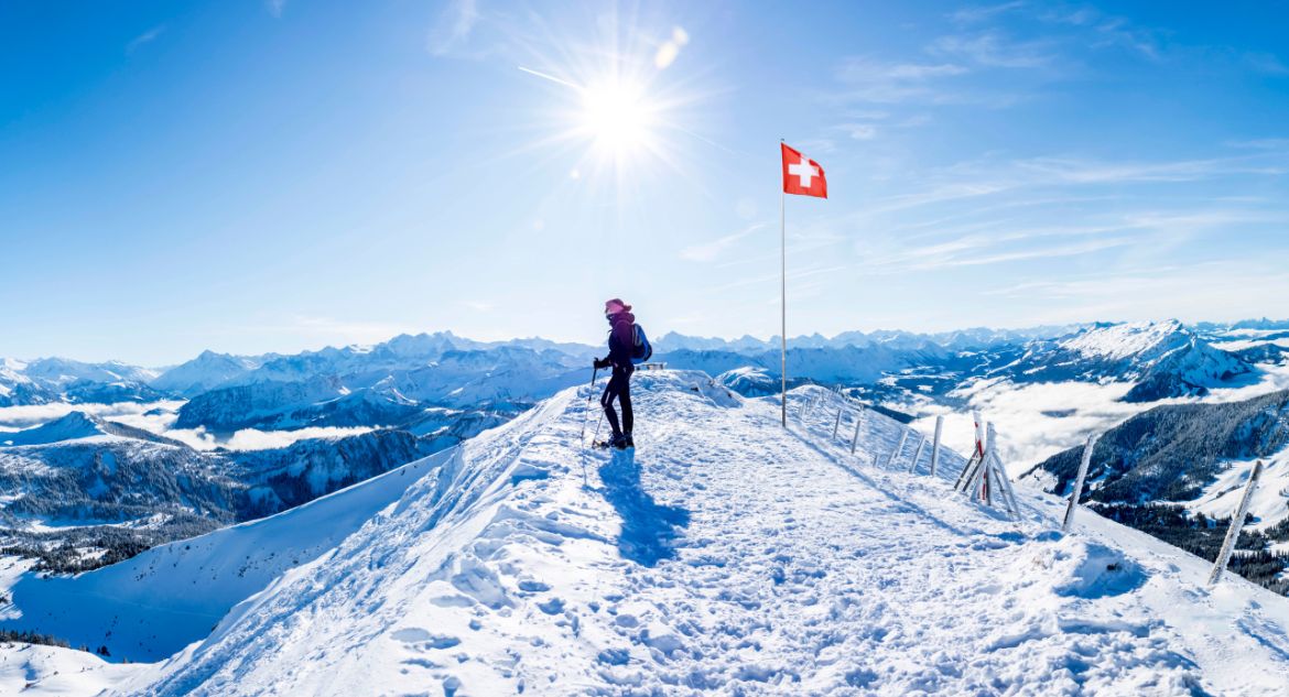 Esportista com vista para os montes nevados da Suíça