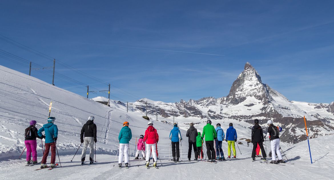 Grupo de esportistas em frente a montanha matterhorn, em zermatt